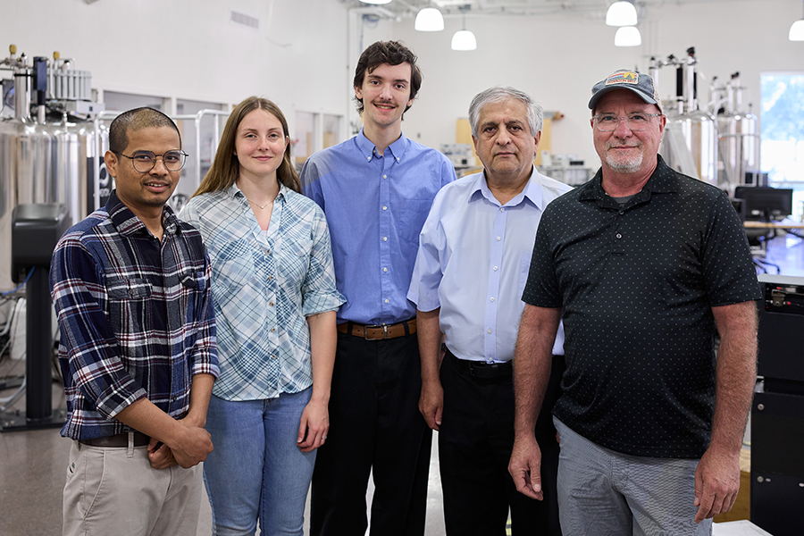 Students working in the NMR lab with lab director Novrus Akhmedov and chair of the Department of Chemistry and Biochemistry, John Peters.